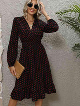 a woman wearing a black and red polka dot dress