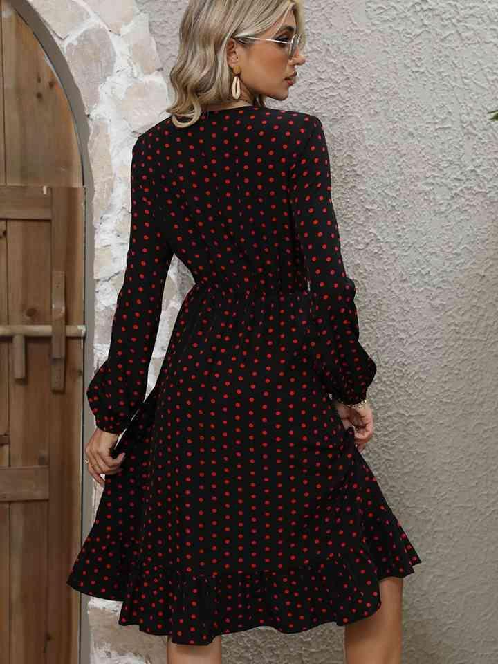 a woman wearing a black and red polka dot dress