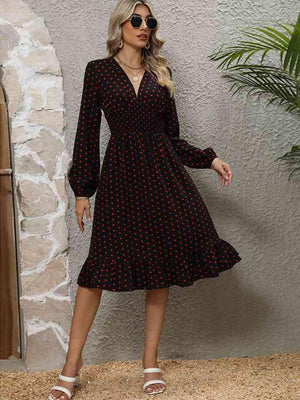 a woman wearing a black and red polka dot dress