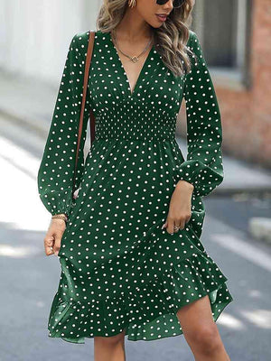 a woman wearing a green polka dot dress