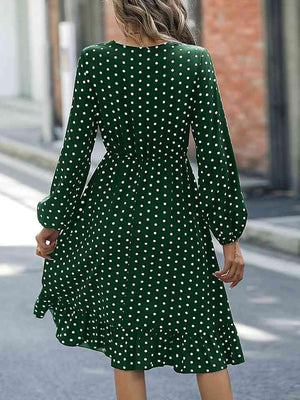 a woman in a green polka dot dress