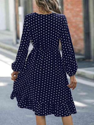 a woman walking down a street wearing a polka dot dress