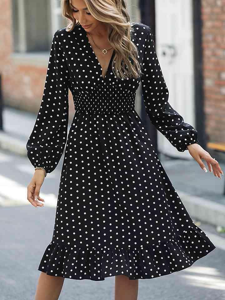 a woman in a black and white polka dot dress