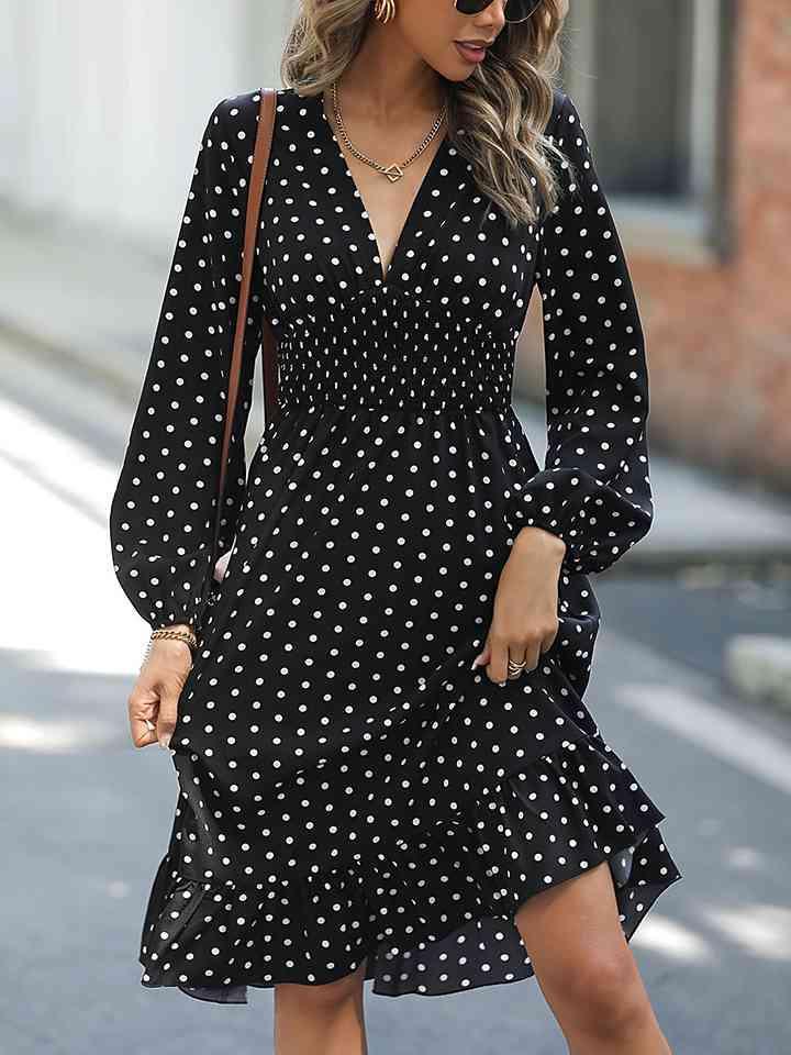 a woman wearing a black and white polka dot dress