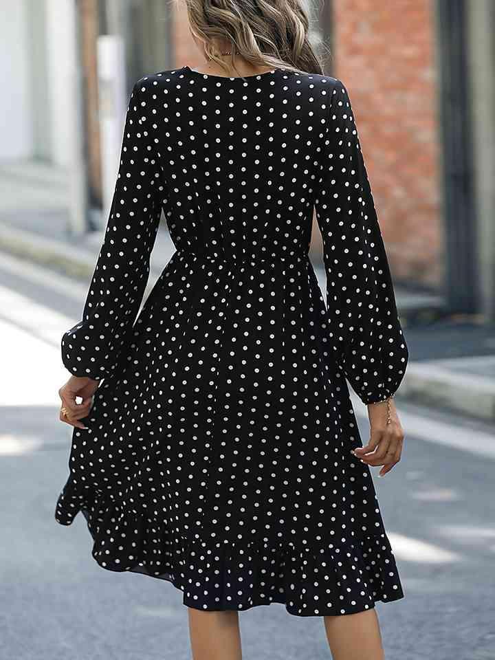 a woman walking down a street wearing a polka dot dress