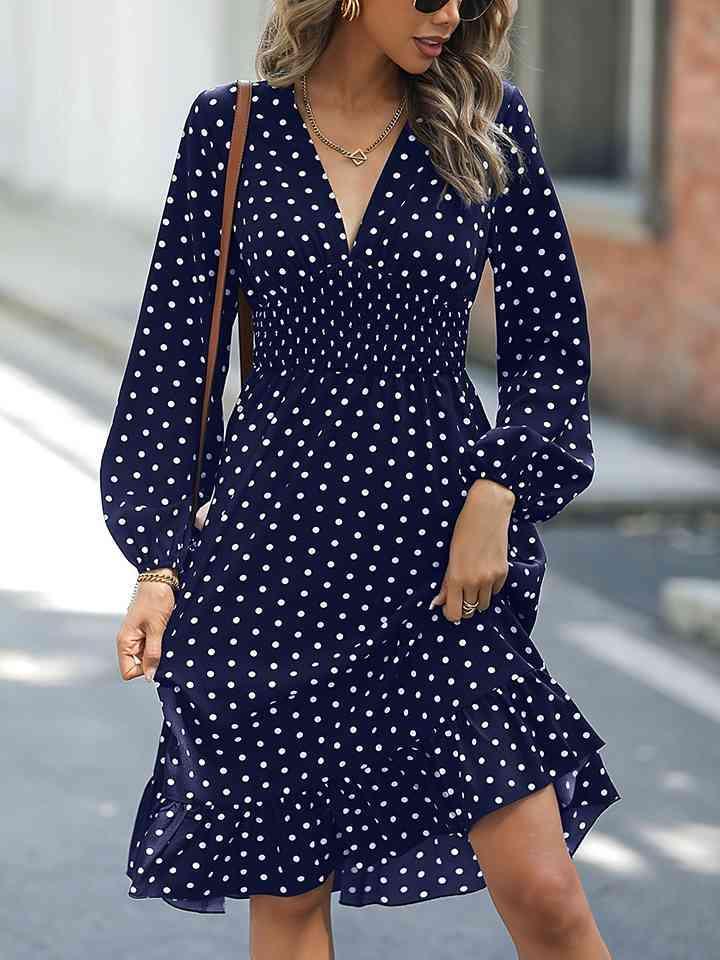 a woman wearing a blue polka dot dress