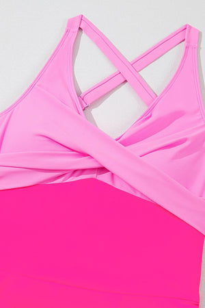 a pink sports bra with a cross back