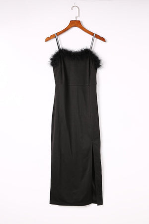 a black dress hanging on a wooden hanger