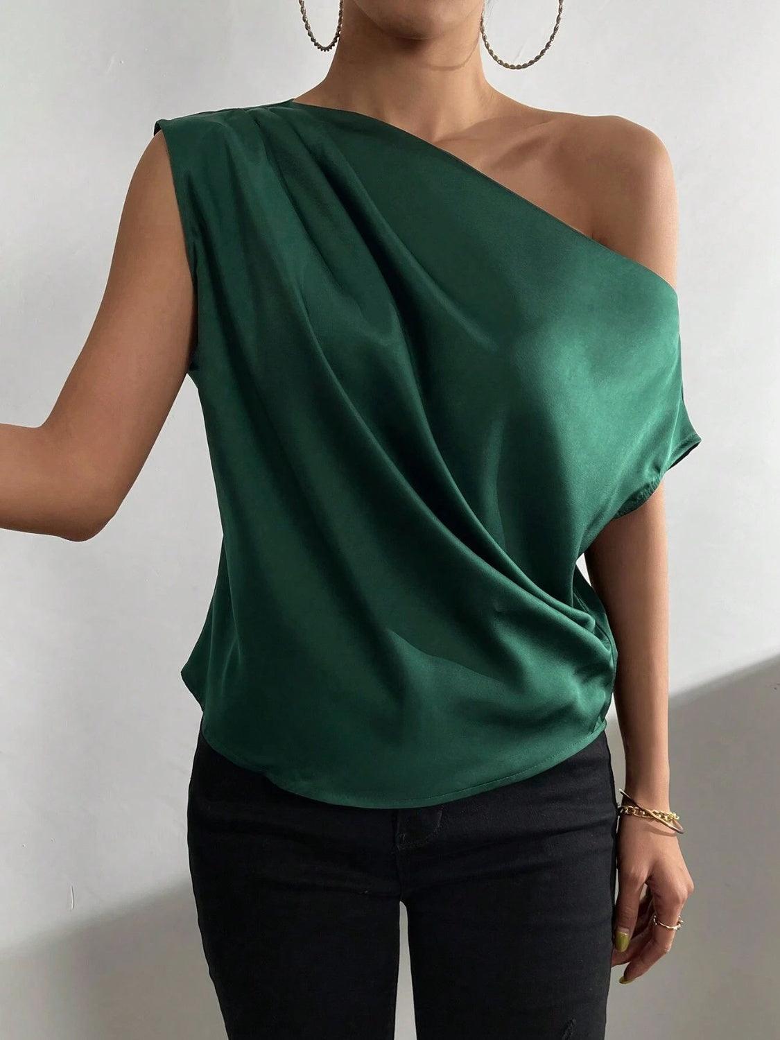 a woman in a green top is posing for a picture