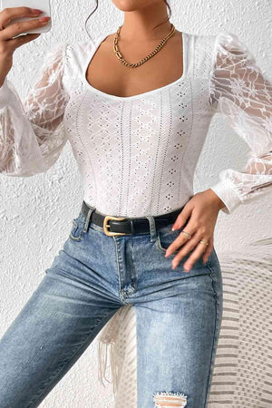 a woman wearing a white top and jeans