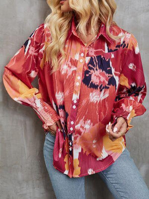 a woman wearing a red floral shirt and jeans