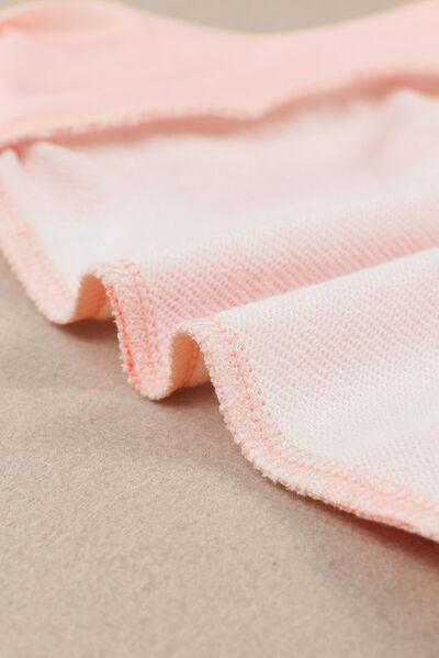 a close up of a pink and white blanket