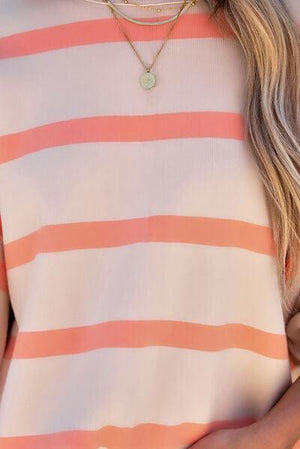 a woman wearing a pink and white striped top