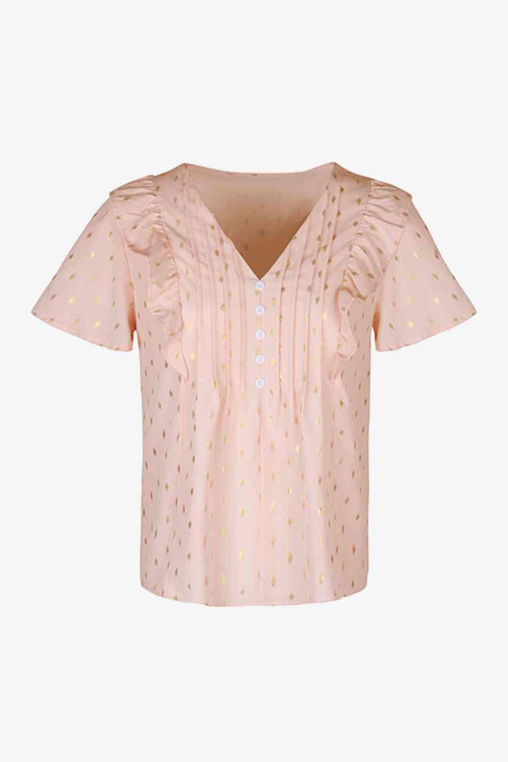 a pink top with gold dots on it