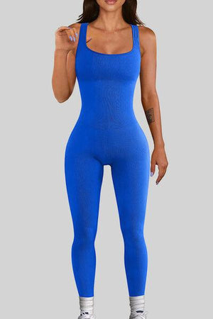 a woman in a blue bodysuit posing for the camera