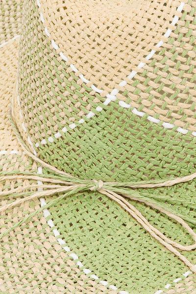 a close up of a straw hat with a knot