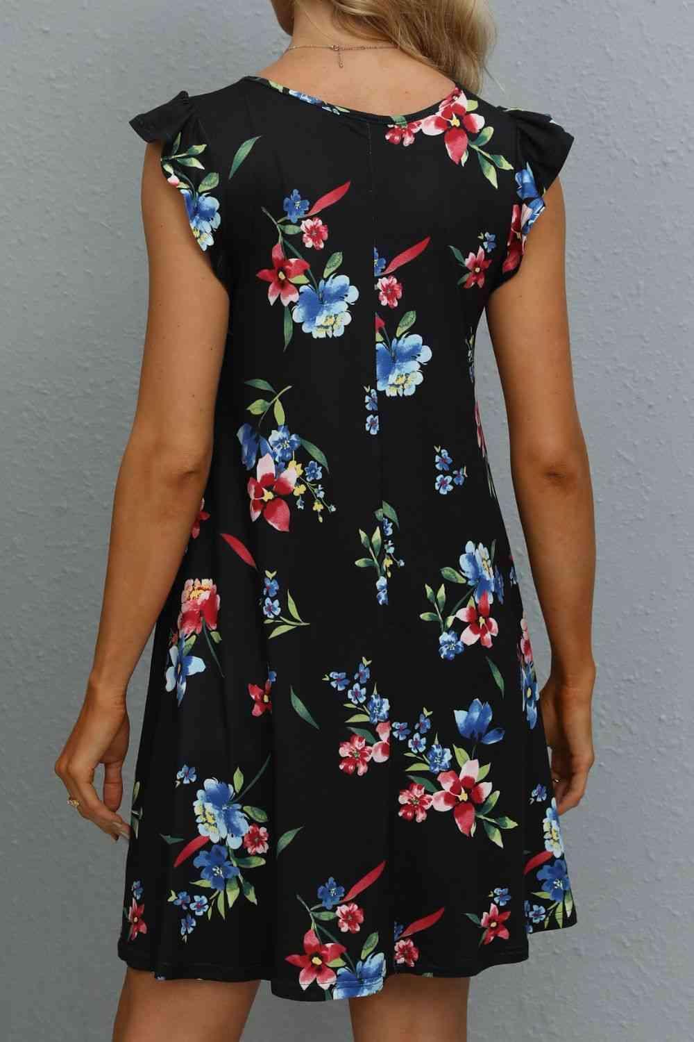 the back of a woman wearing a black floral dress