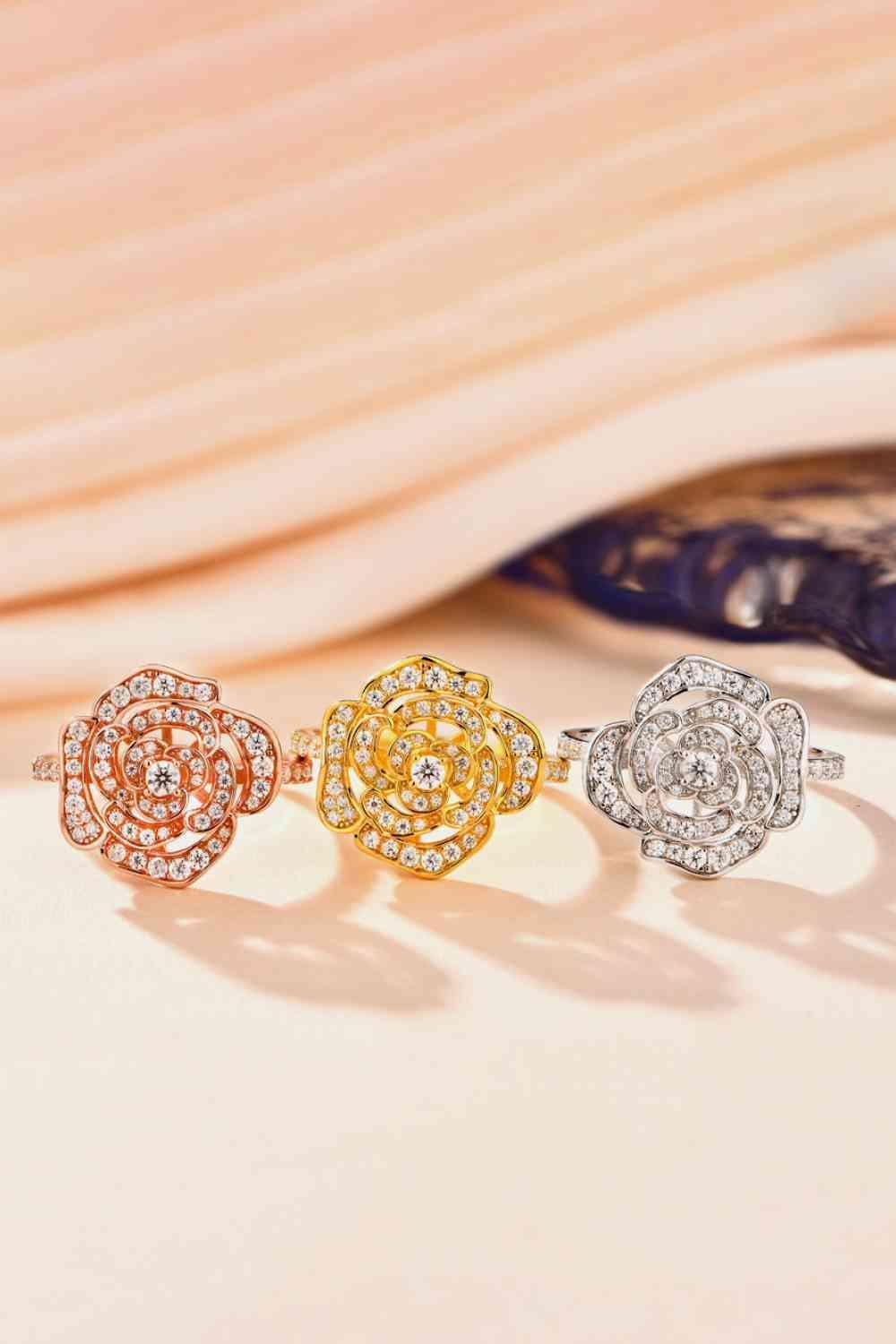 three different colored diamond rings sitting on top of a table