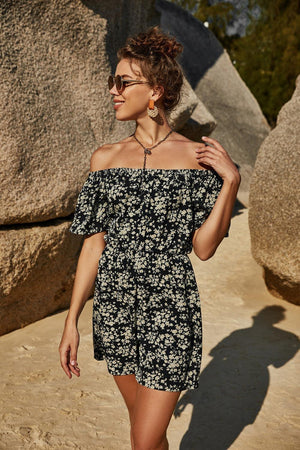 a woman in a black and white floral dress