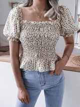 a woman standing in a kitchen wearing a white top