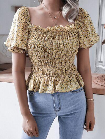 a woman standing in a kitchen wearing a yellow top