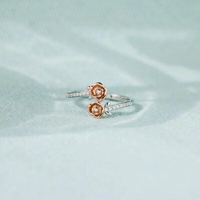 a rose ring sitting on top of a white cloth