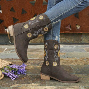 a woman's boots with sunflowers on them