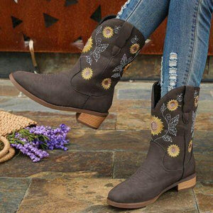 a pair of brown cowboy boots with sunflowers on them