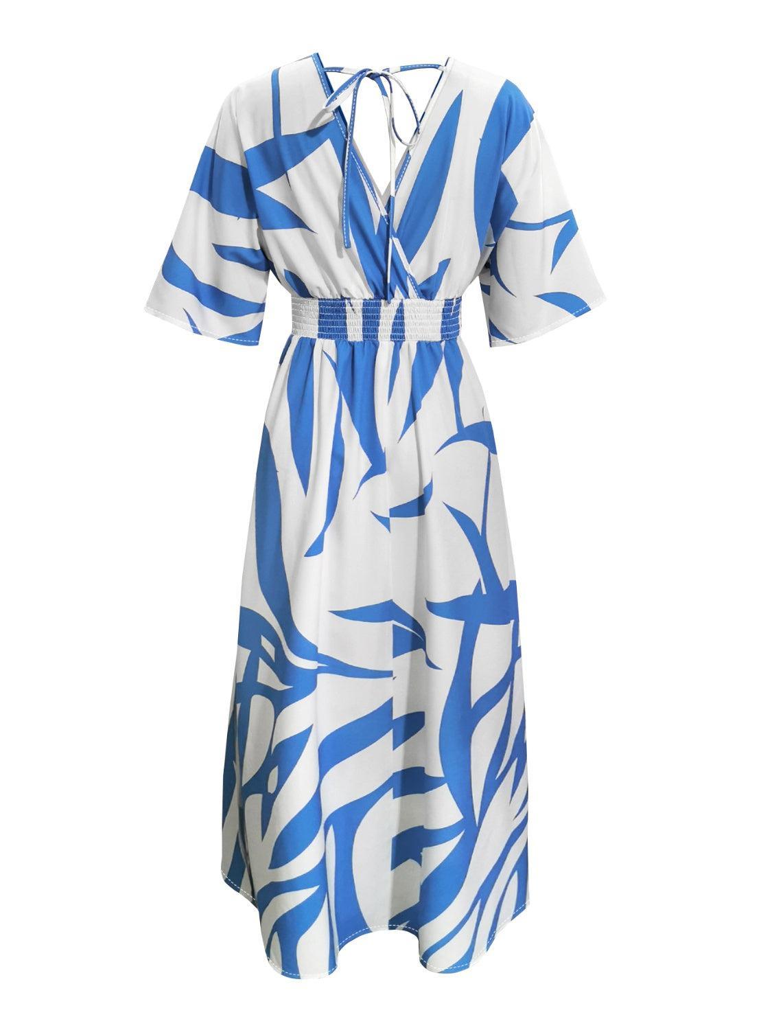 a white and blue dress with blue leaves on it