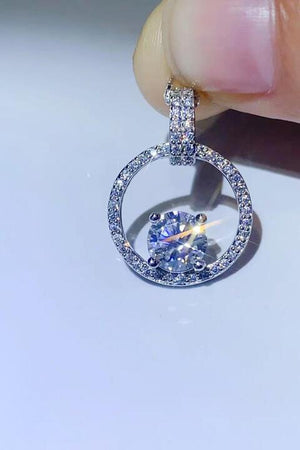 a person holding a diamond ring in their hand