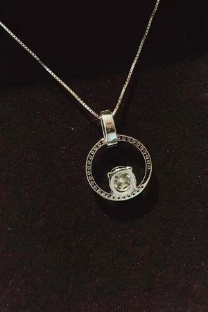 a silver necklace with a diamond in the middle