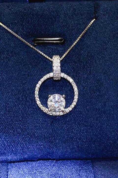 a diamond pendant on a blue velvet box