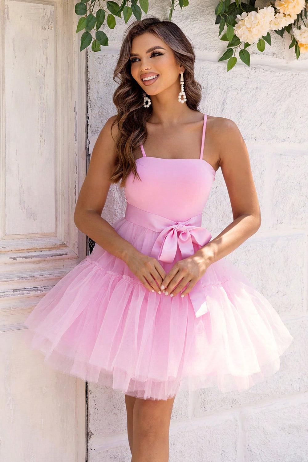 a woman in a pink dress posing for a picture