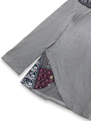 a gray shirt with a colorful patchwork pocket