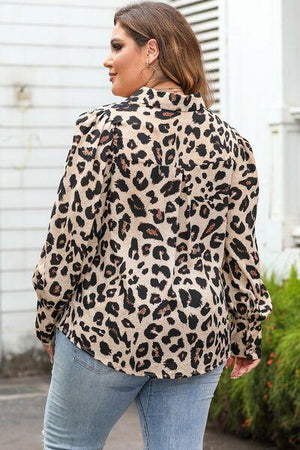 a woman wearing a leopard print jacket and jeans