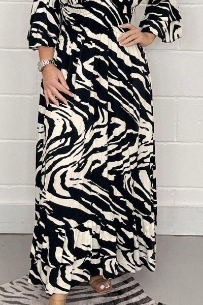 a woman wearing a black and white zebra print dress