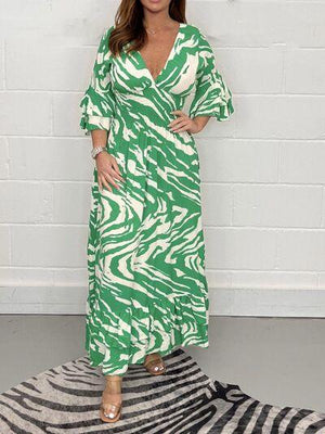 a woman in a green and white dress