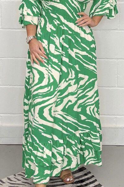 a woman wearing a green and white zebra print dress