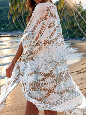 a woman is walking on the beach in a dress