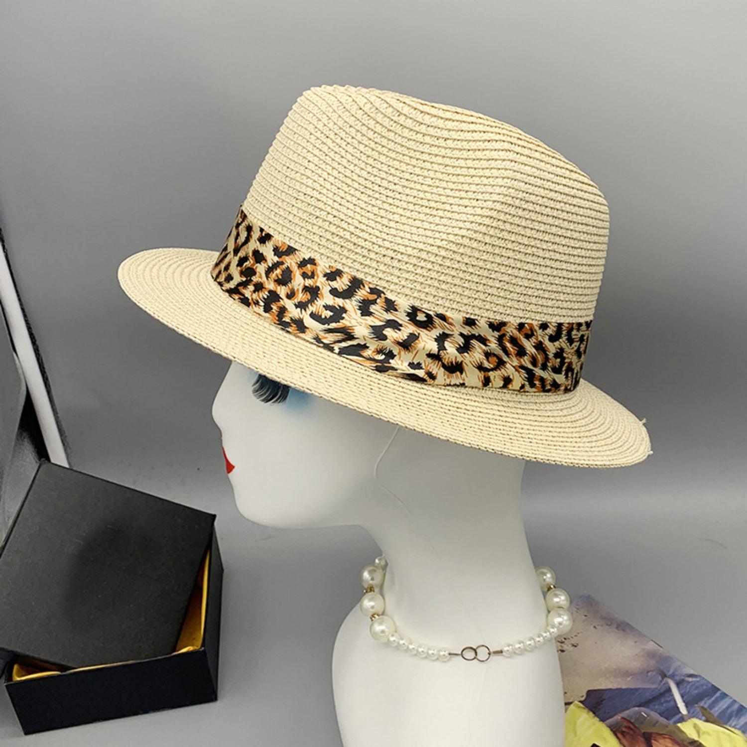 a mannequin head wearing a hat with a leopard print band