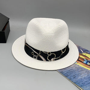 a white hat sitting on top of a table next to a book