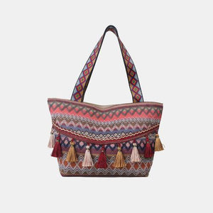 a multicolored tote bag with tassels