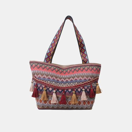 a multicolored tote bag with tassels