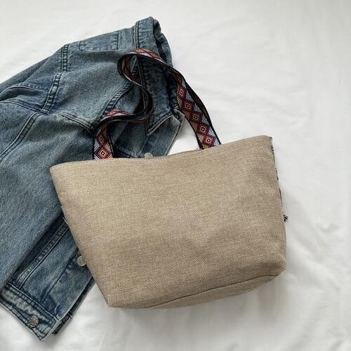 a pair of jeans sitting on top of a bed