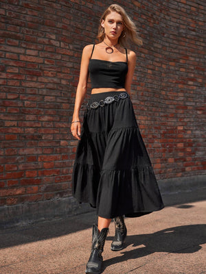 a woman in a black top and a black skirt