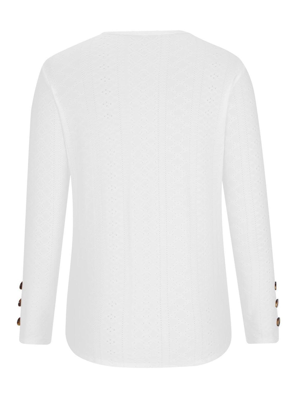 a white sweater with buttons on the sleeves