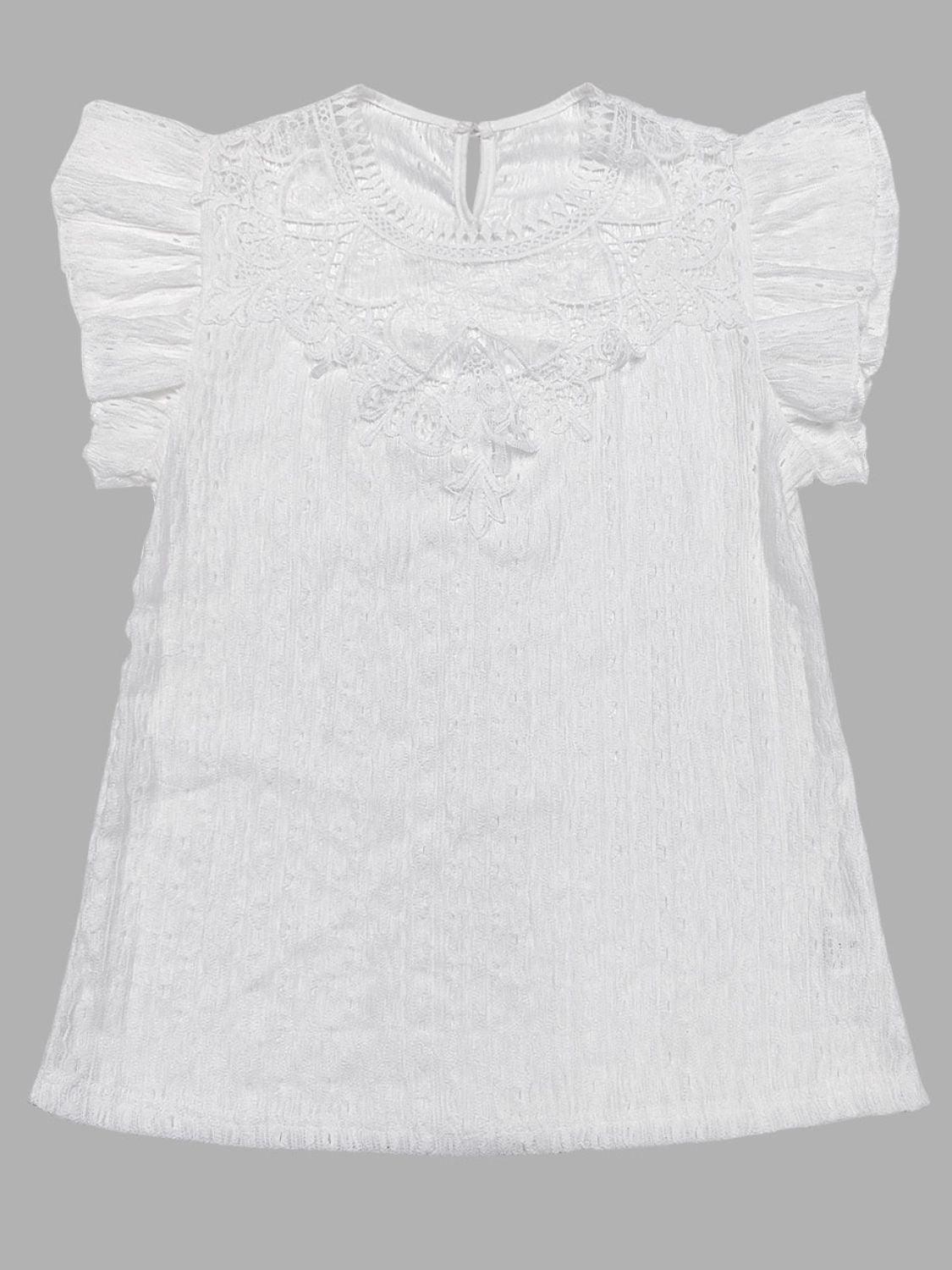 a white blouse with a frilled neckline