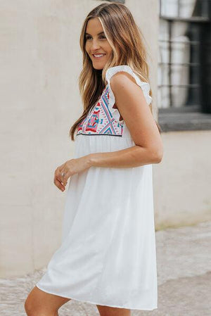 a woman wearing a white dress and sandals