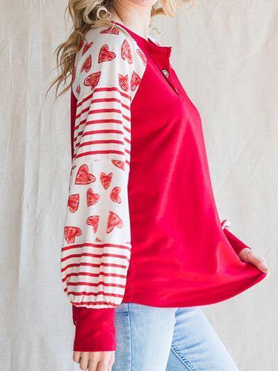 a woman wearing a red and white shirt with hearts on it