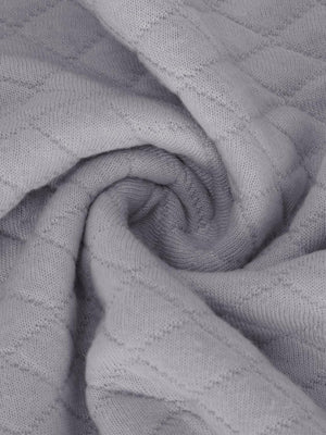 a close up of a blanket on a bed
